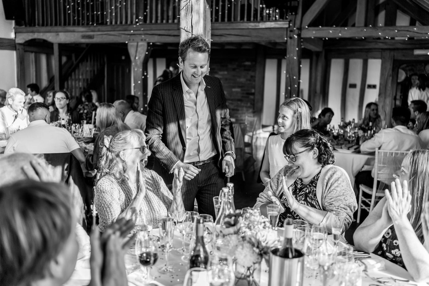 Richard Kettle performing close-up card magic at a wedding, black and white