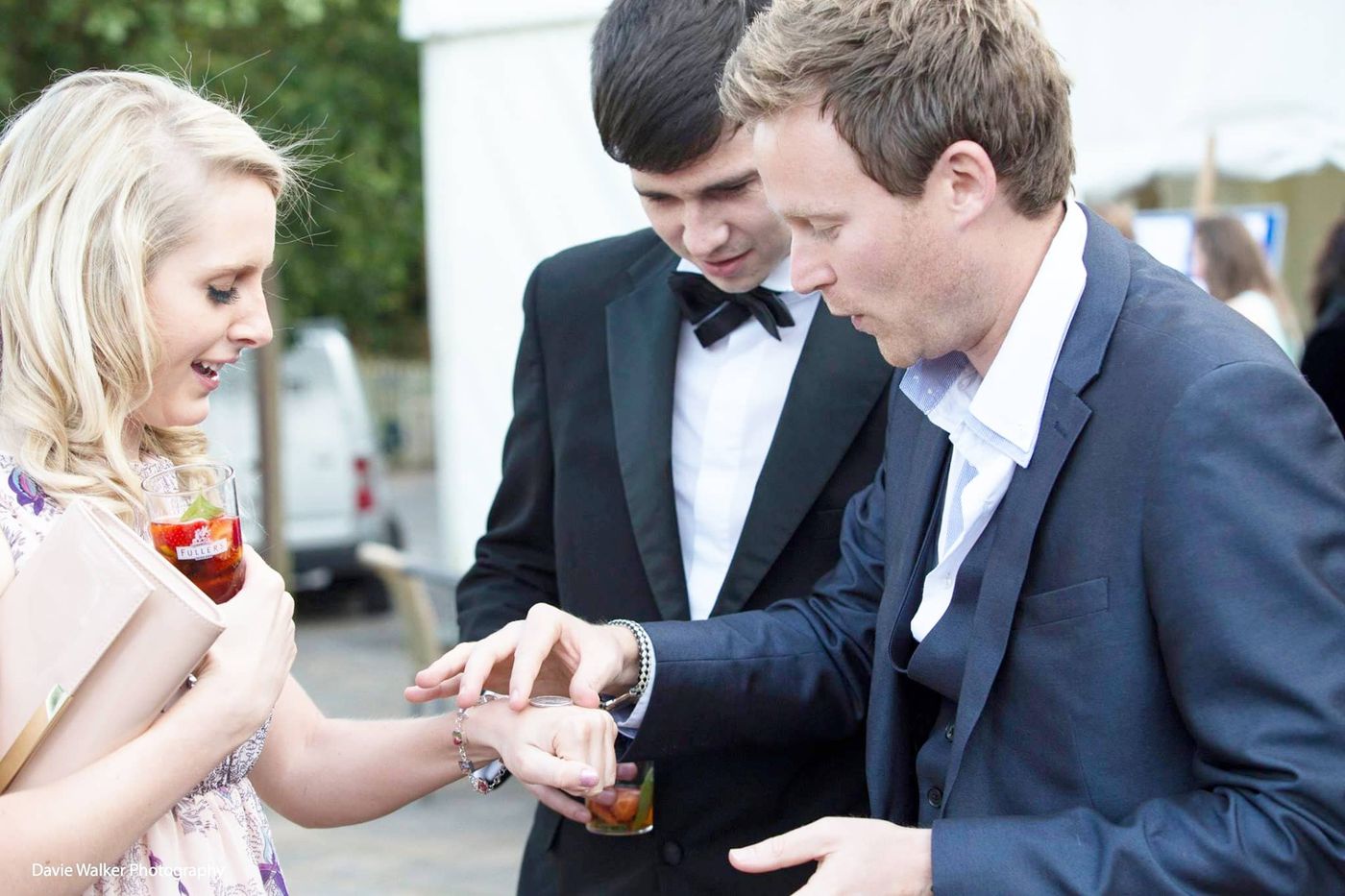 Richard Kettle performing close-up magic in black tie at a corporate event