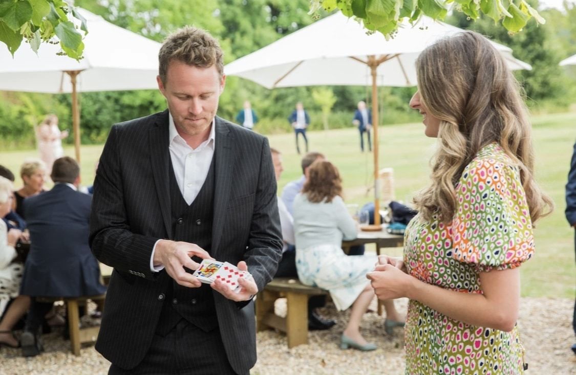 Guests reacting to close-up magic at a corporate event