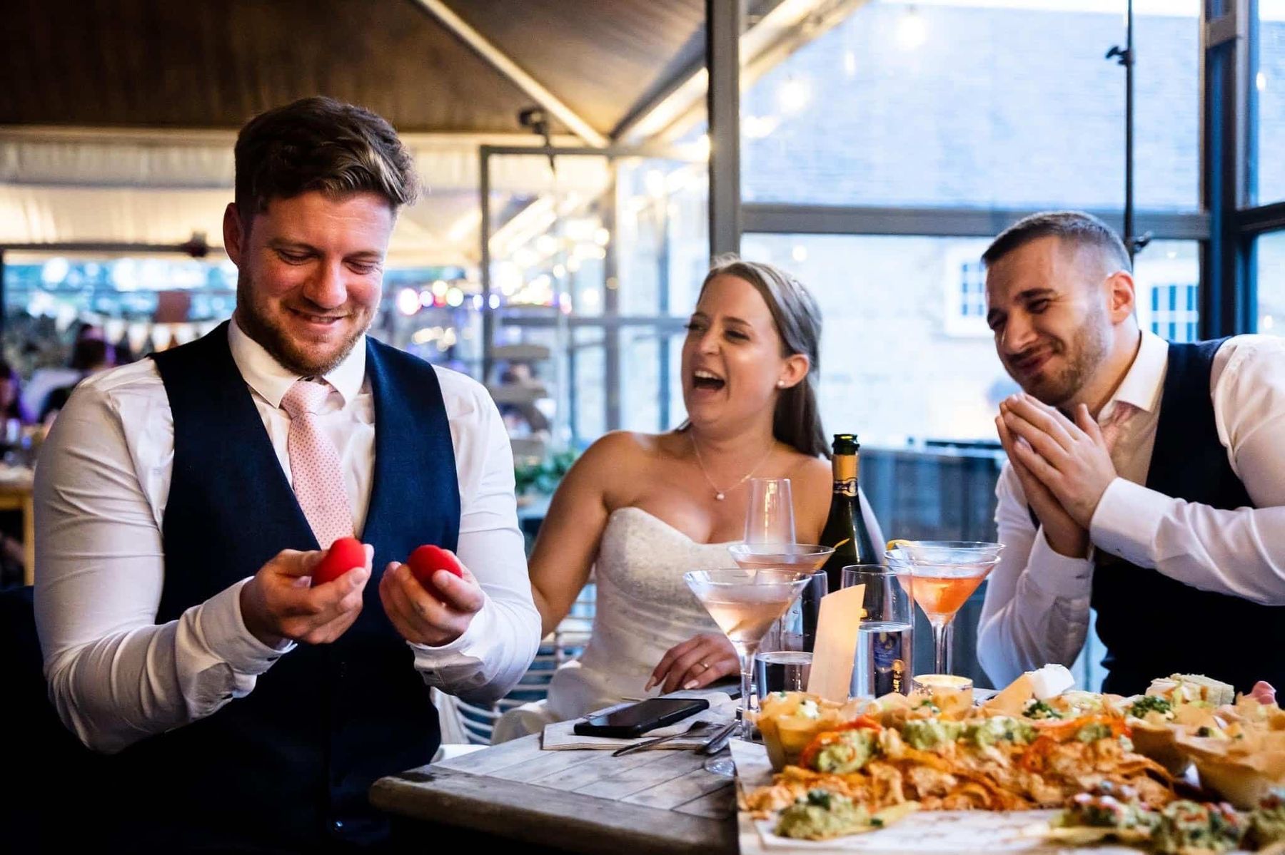 A guest laughing in open-mouthed disbelief during close-up wedding magic