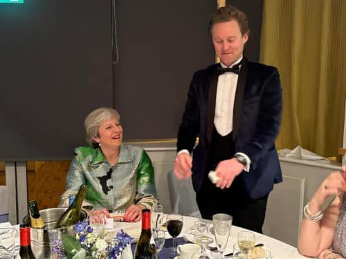 Richard Kettle performing close-up magic at a formal dinner event