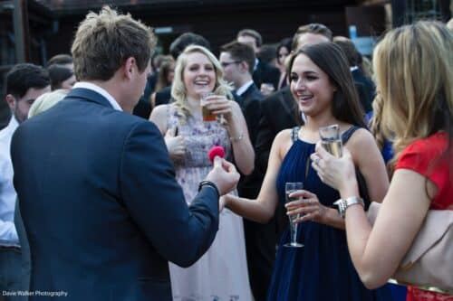 Wedding guests reacting with delight to a card trick