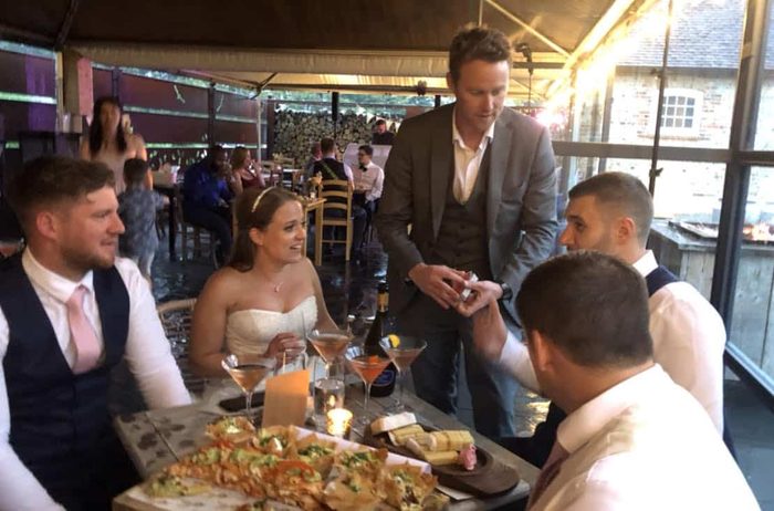 A guest reacting with delight during wedding magic