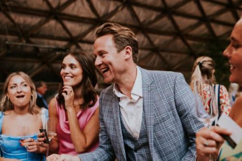 A group of guests laughing together at a party