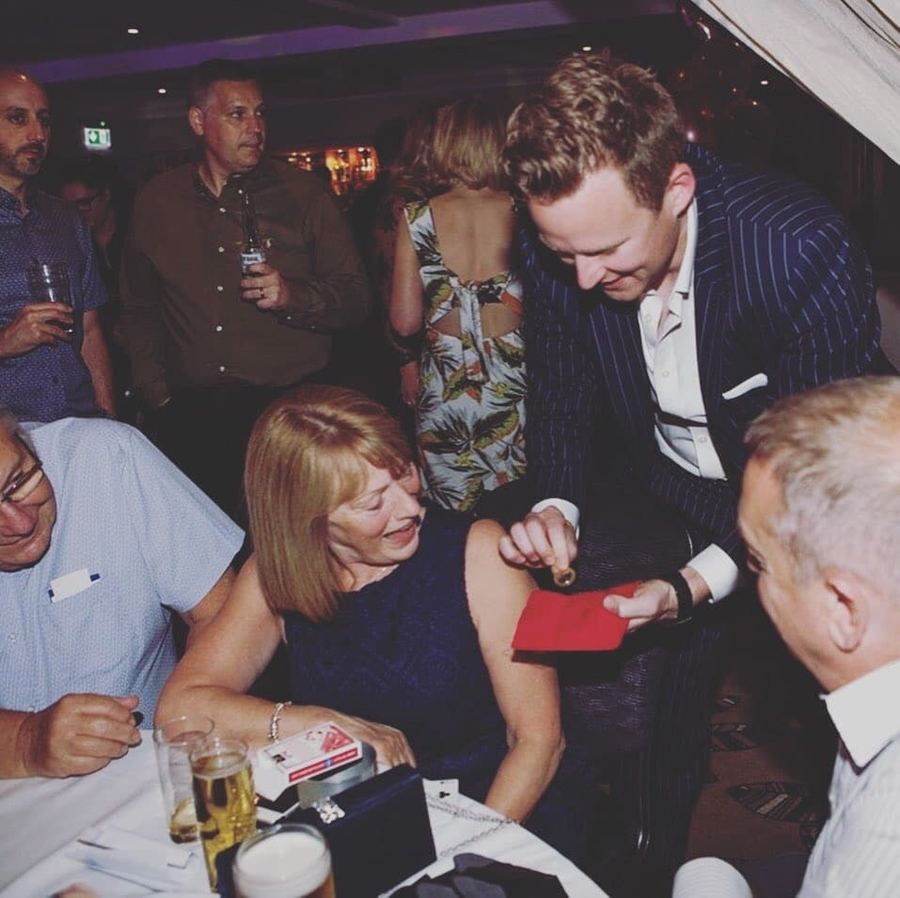 A guest watching closely during a coin trick