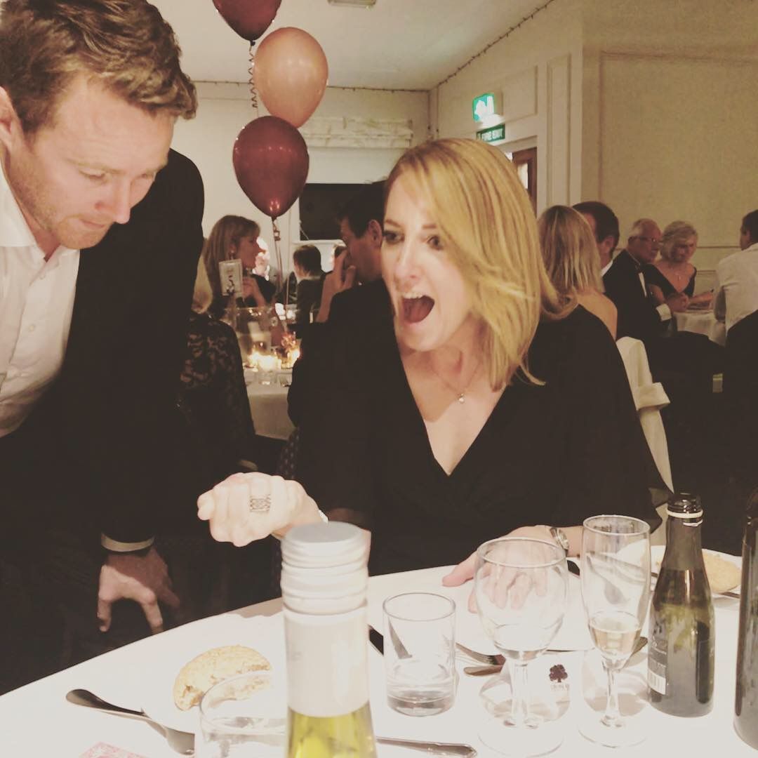 A guest reacting in astonishment during close-up magic at a birthday party near Woking