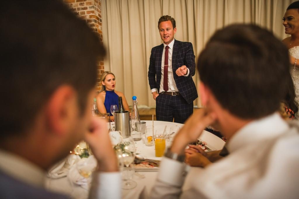 Richard Kettle performing for a table of guests during a wedding breakfast