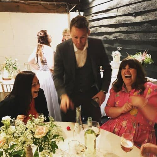 Wedding guests laughing together during magic