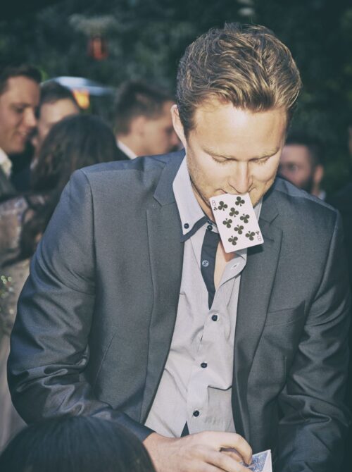 magician-performing-in-surrey-with-card-in-his-mouth